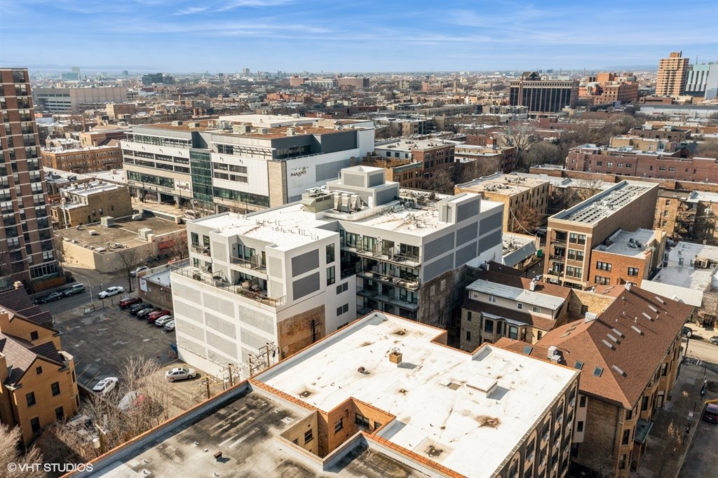 A cityscape with buildings of various sizes and a clear sky.