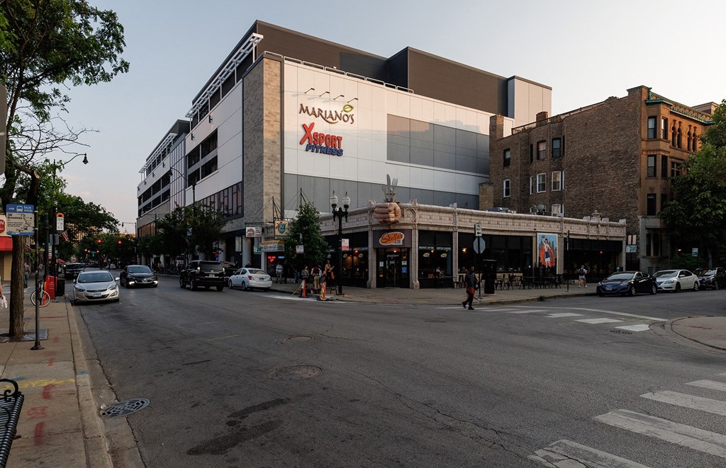 a large building with a sign on the side of a street