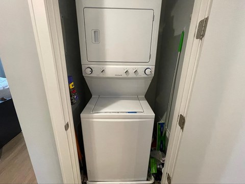 A white dishwasher is built into a kitchen cabinet.
