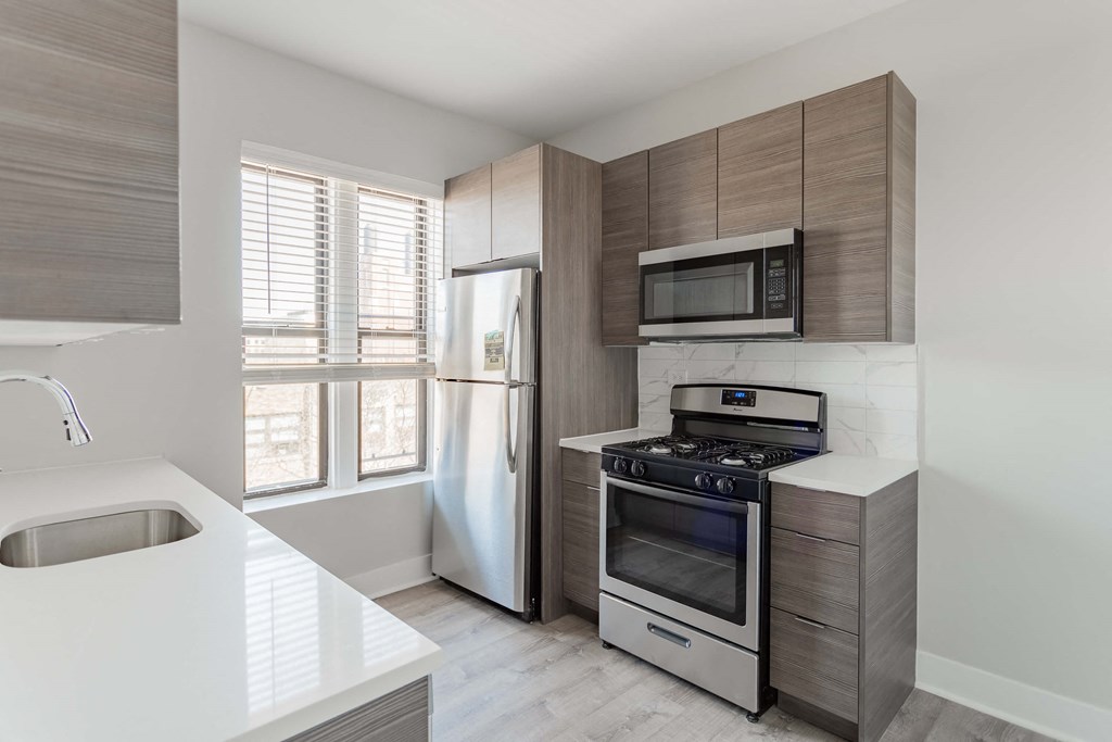 a kitchen with stainless steel appliances and wooden cabinets