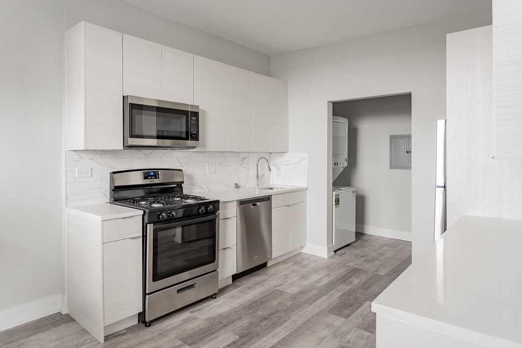 a kitchen with stainless steel appliances and white cabinets