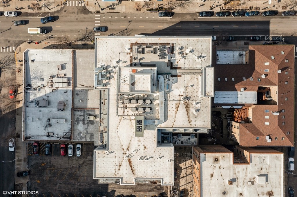 An aerial view of a city with buildings and cars.