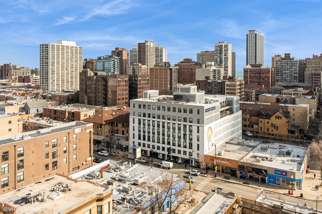 A cityscape with buildings of various heights and a clear sky.