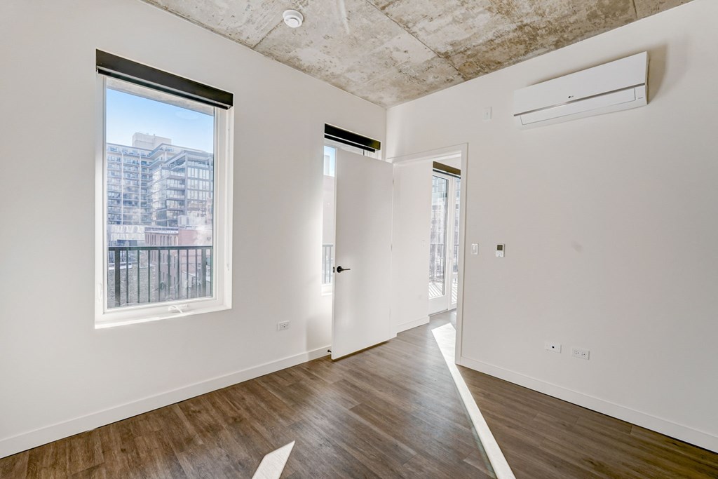 A room with a window and a door.