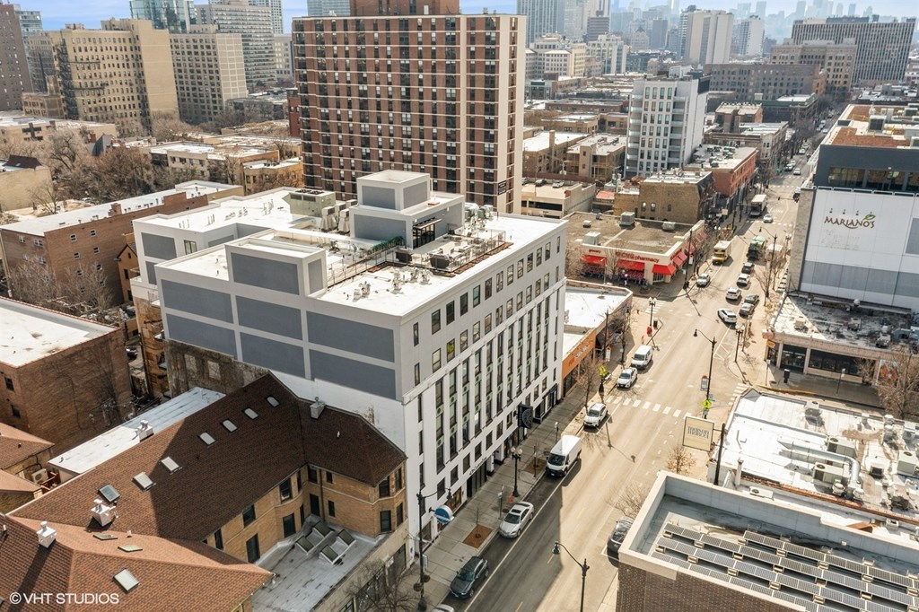 A city street with a large building in the middle.