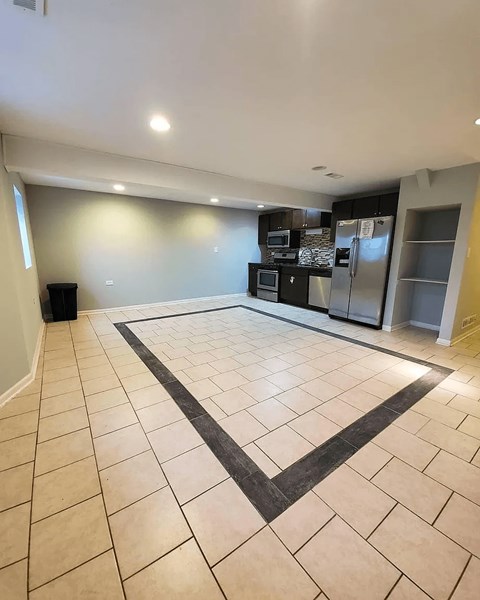 A kitchen with a black and white tile floor.