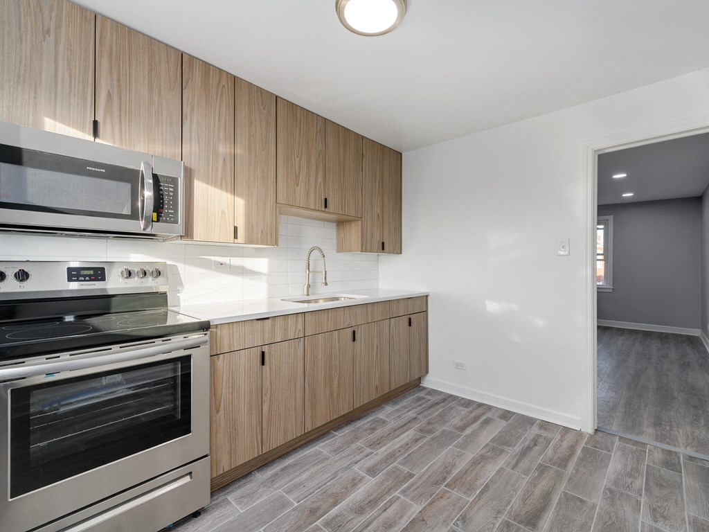 A kitchen with a stove, oven, and microwave.