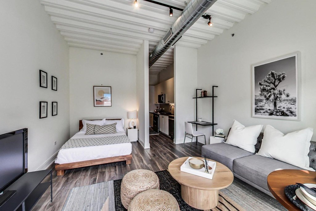 a bedroom with a bed and a tv in a room