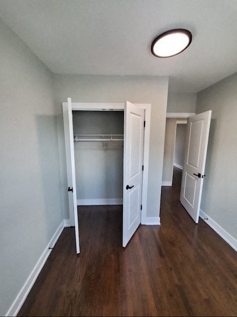 an empty room with a closet and a door open