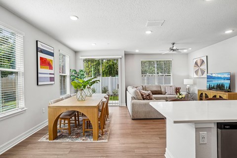 A modern dining room with a wooden table and chairs.