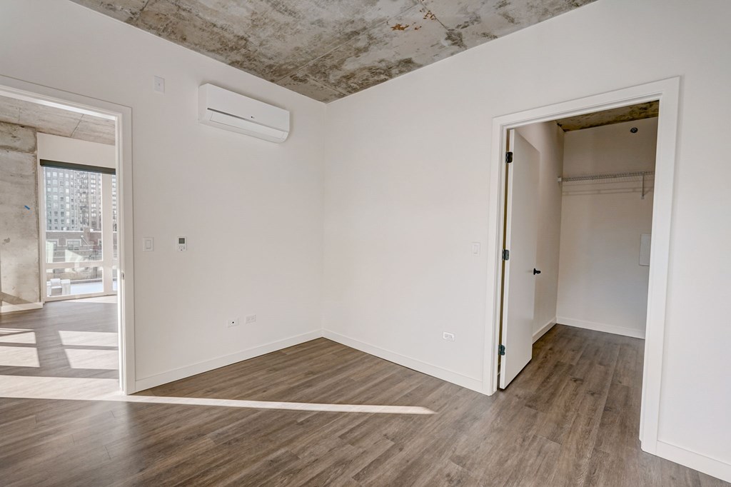 A room with a wooden floor and a ceiling with stains.