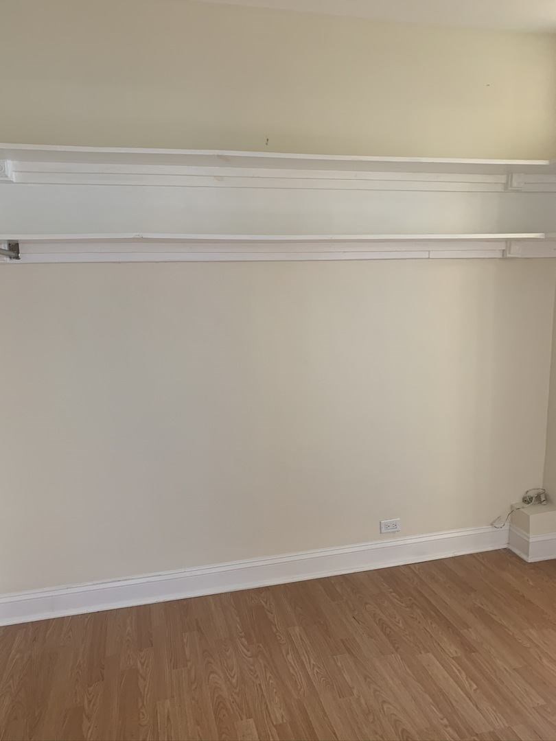 a empty room with white walls and a wooden floor