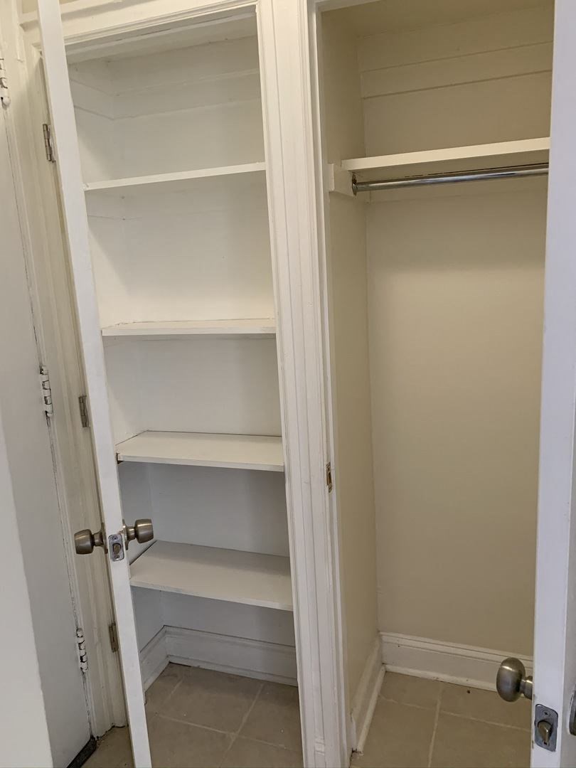 a small closet with empty shelves and a door