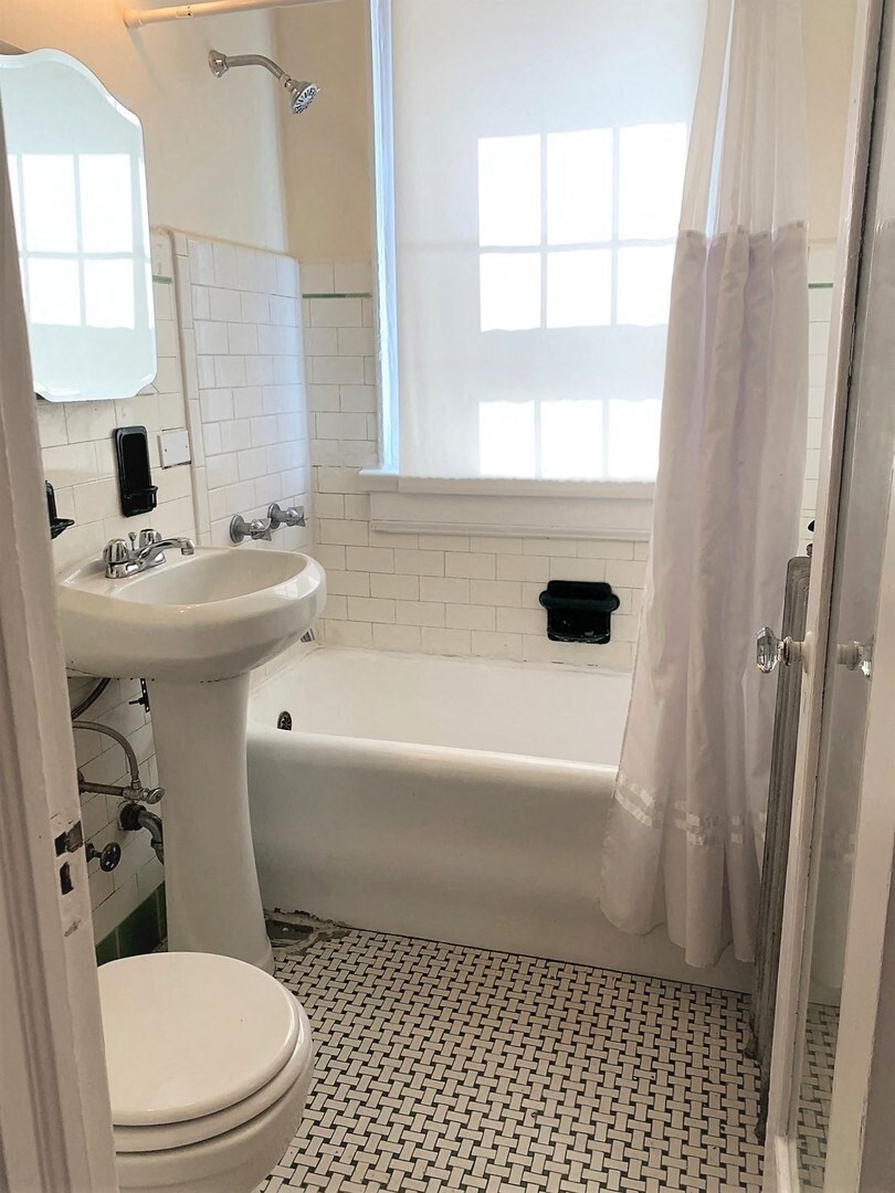 a bathroom with a sink toilet and a bath tub