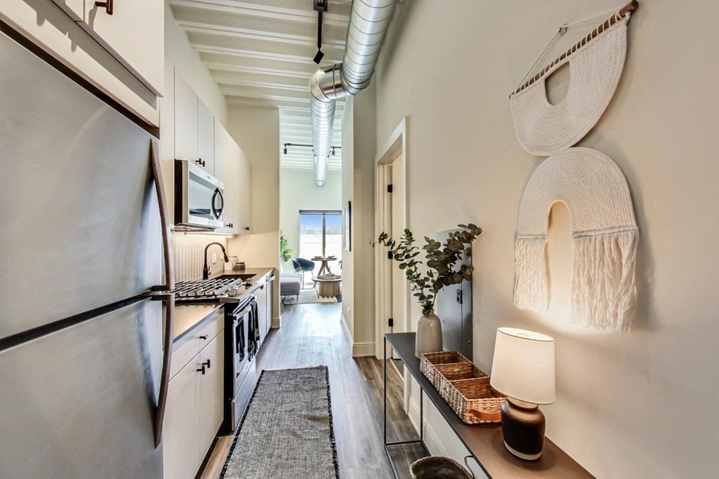 a kitchen with a refrigerator freezer next to a stove top oven