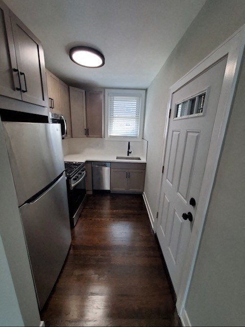 a kitchen with stainless steel appliances and a white door