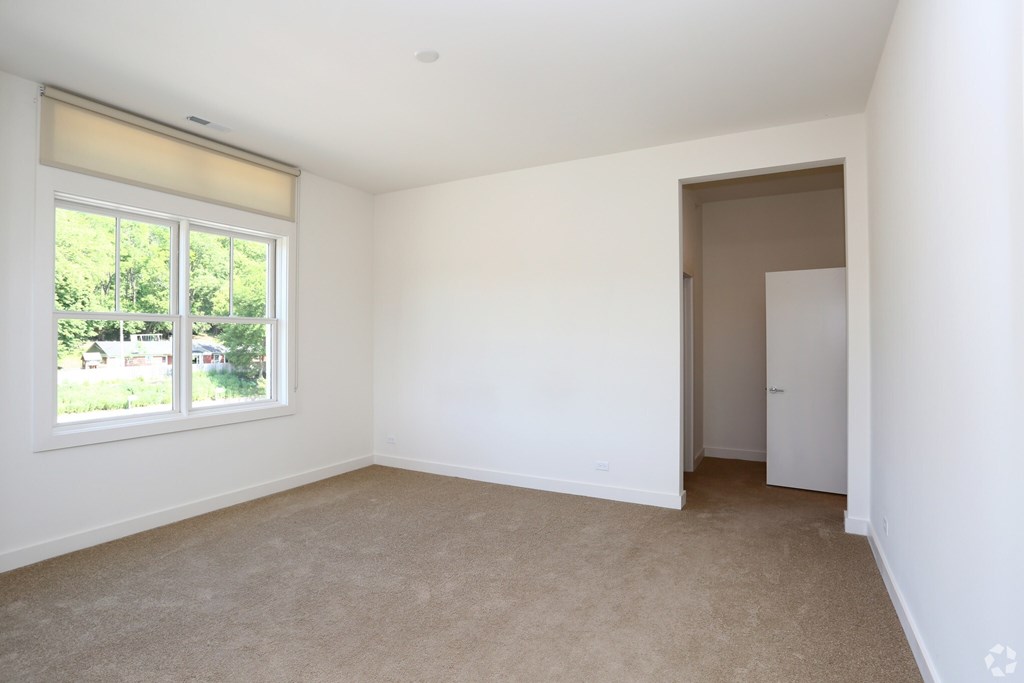 A room with a window and a door.