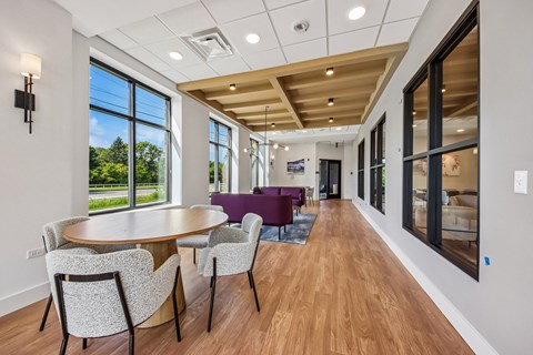 A dining room with a round table and chairs.
