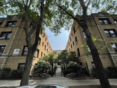 the entrance to a building with trees in front of it