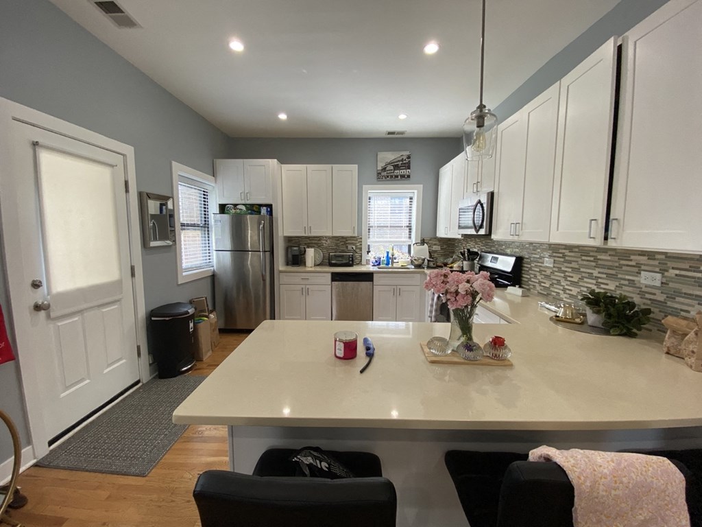 a kitchen with white cabinets and a white counter top