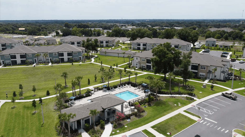 A bird's eye view of a residential area with a swimming pool.