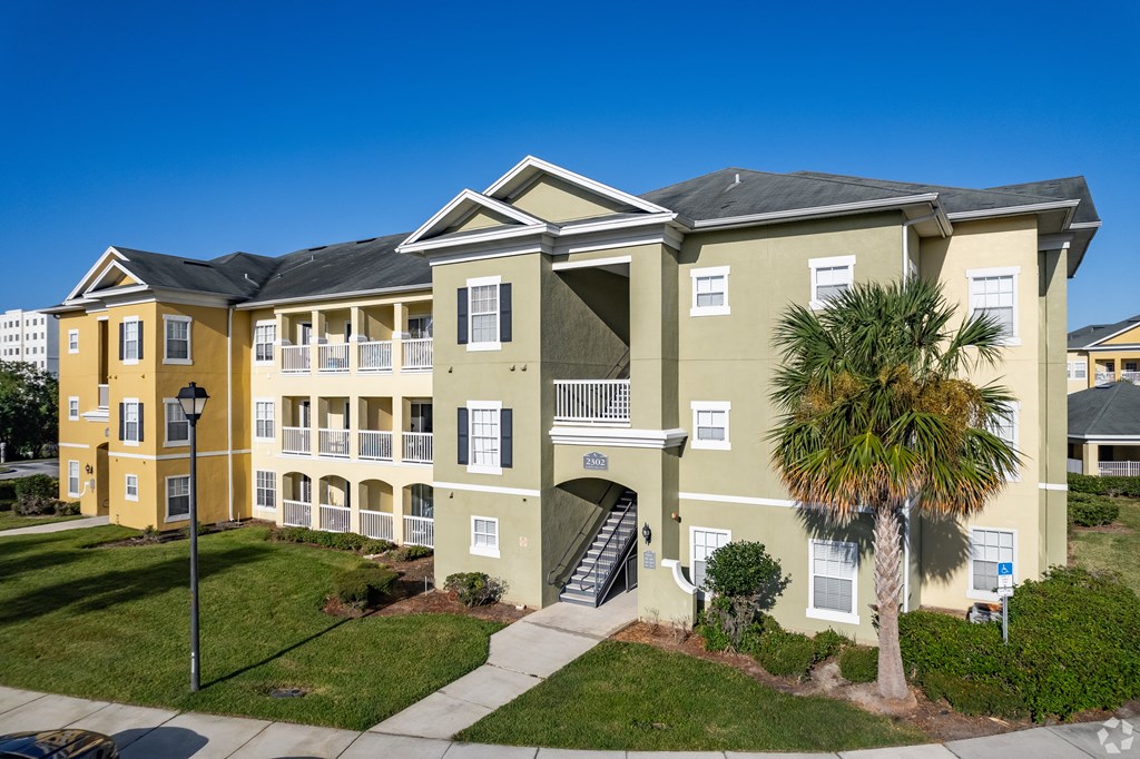 A building with a palm tree in front of it.