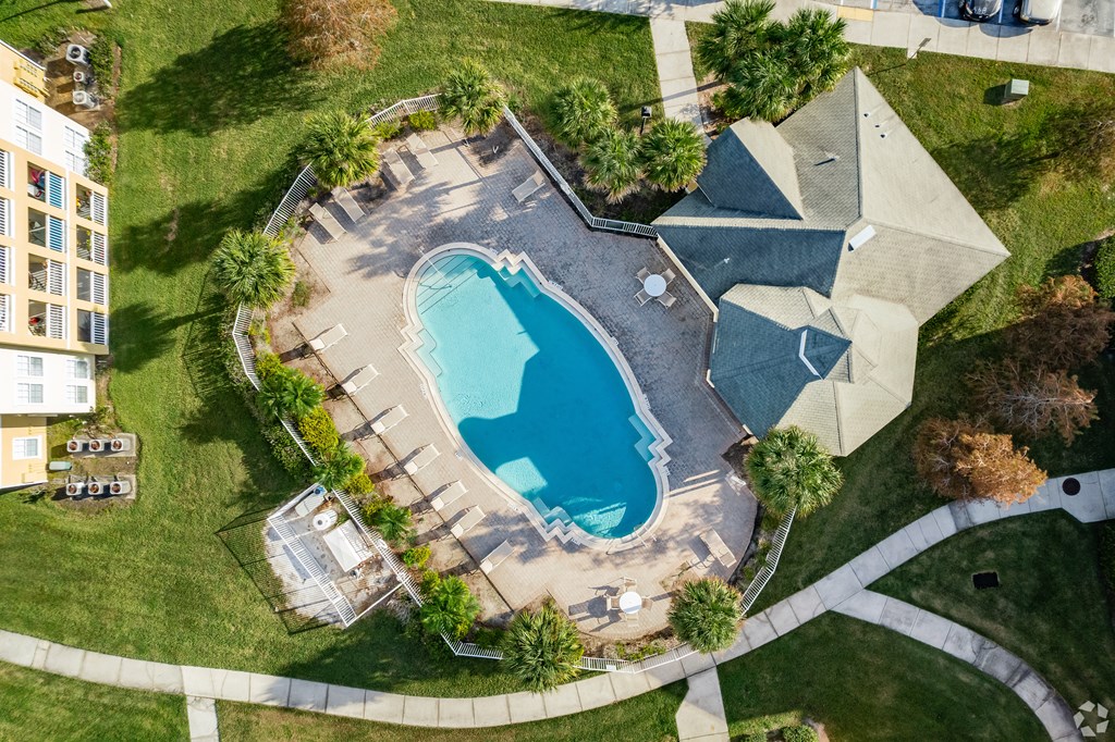 An aerial view of a house with a swimming pool.