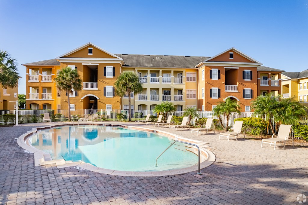 A large building with a pool in front.
