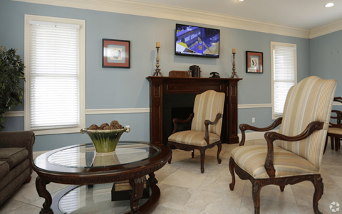 A living room with a brown coffee table and striped armchair.