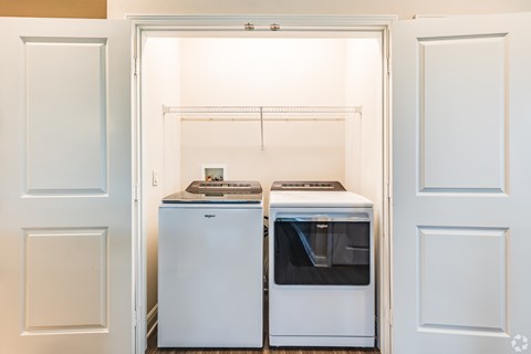 A white refrigerator and freezer are in a kitchen.