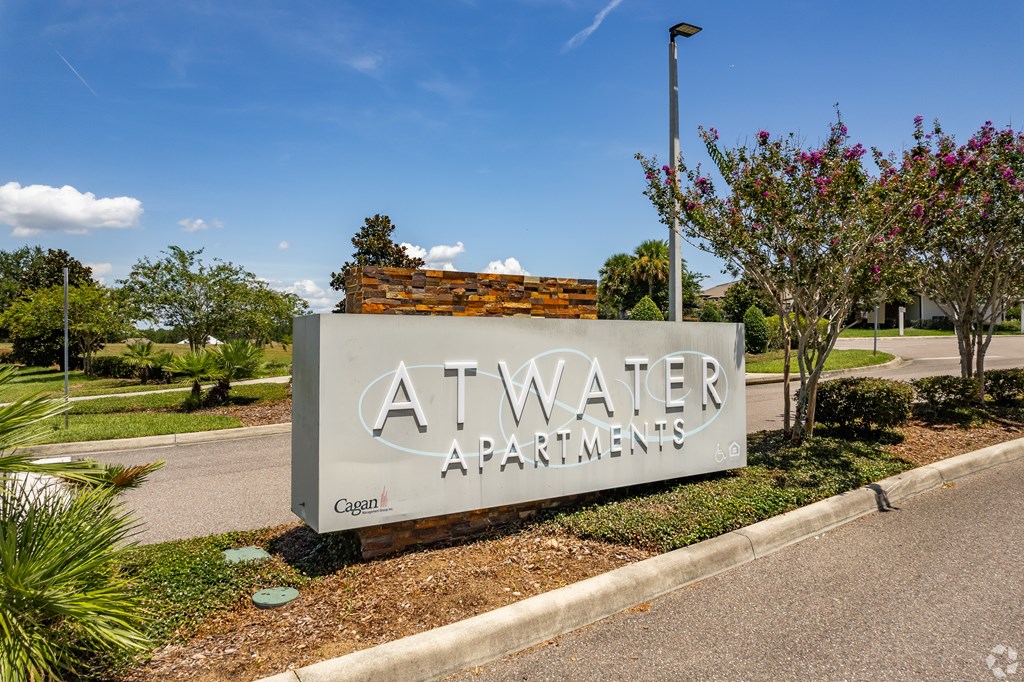 A sign for Atwater Apartments is displayed in front of a building.