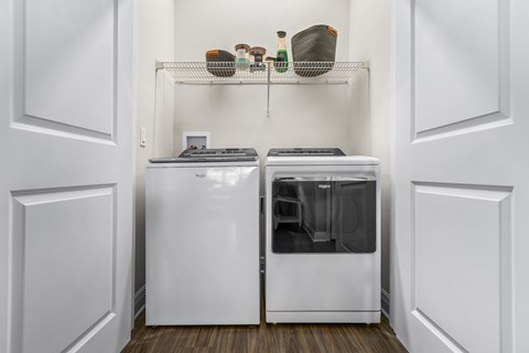 A white kitchen with a dishwasher and a refrigerator.