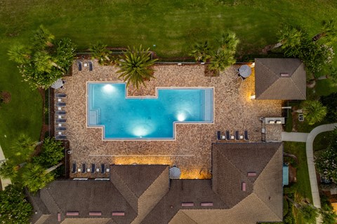 A swimming pool is surrounded by a stone wall.