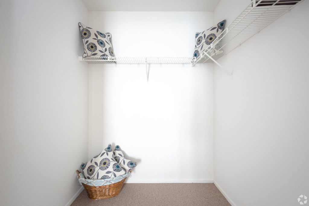 A room with a white wall and a basket on the floor.