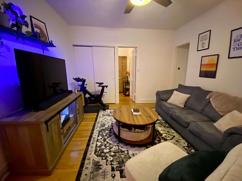 A living room with a grey couch and a wooden coffee table.