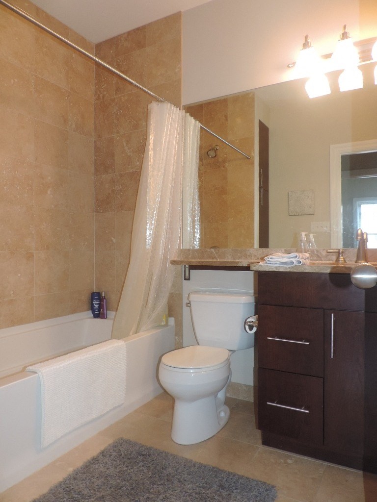 a bathroom with a toilet and a tub and a sink