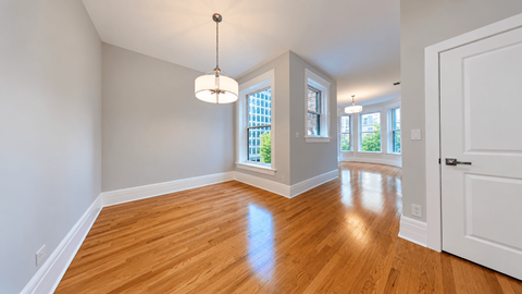 A room with wooden floors and a white door.
