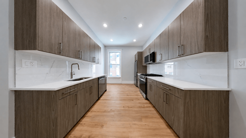 A modern kitchen with wooden cabinets and a white countertop.