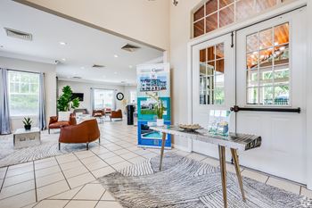 A reception area with a white wall and a blue poster.
