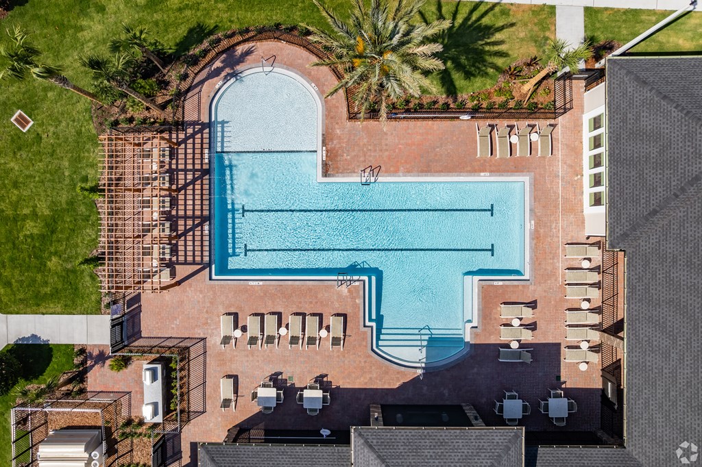 A large swimming pool surrounded by a brick wall.