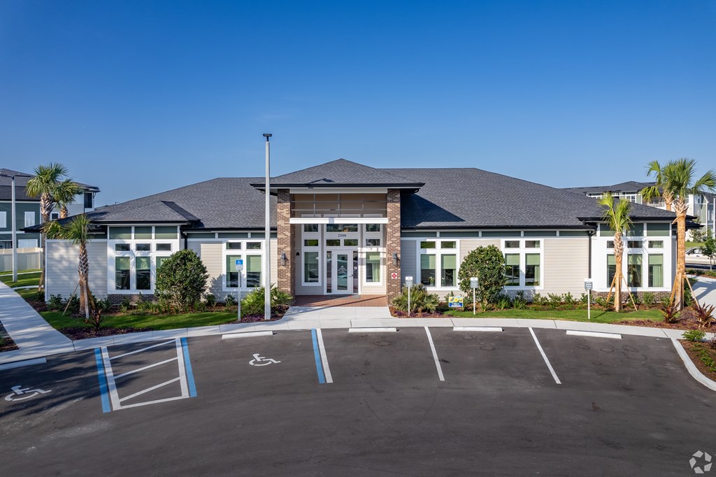 A building with a parking lot in front of it.