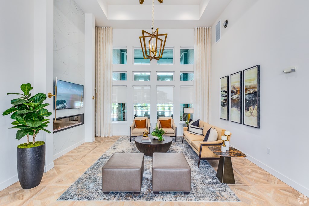 A living room with a large couch, a coffee table, and a TV.