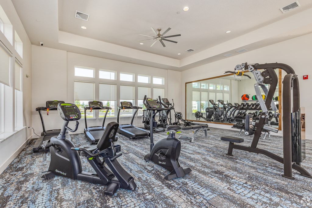 A spacious gym with a variety of exercise equipment.