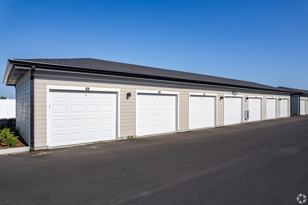 A long building with multiple garage doors.
