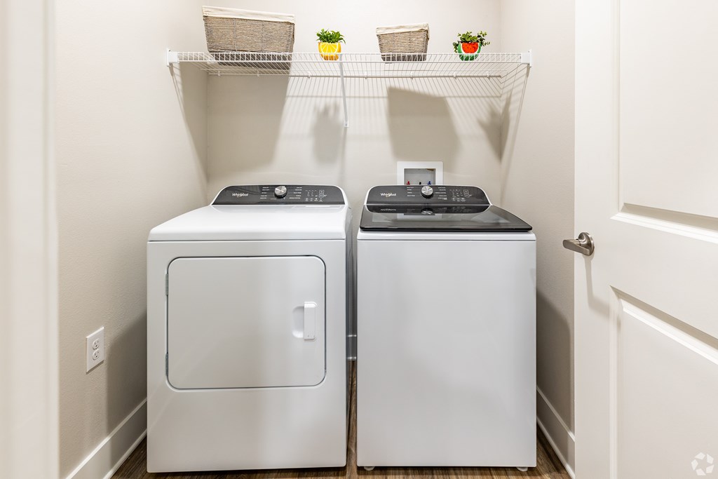 A small laundry room with a washer and dryer.