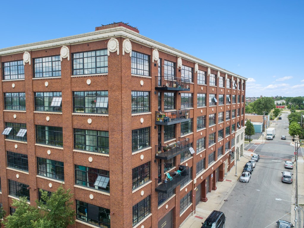 a large brick building with many windows and a street