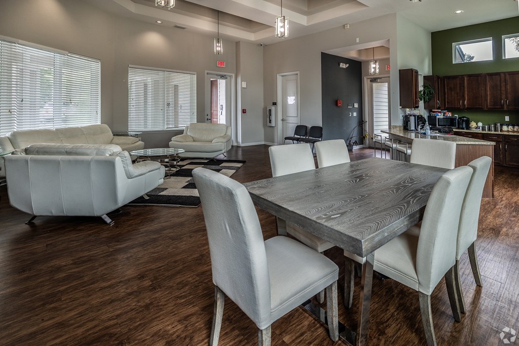 A modern dining room with a large table and chairs.