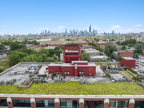 the roof of a factory with a city skyline in the background