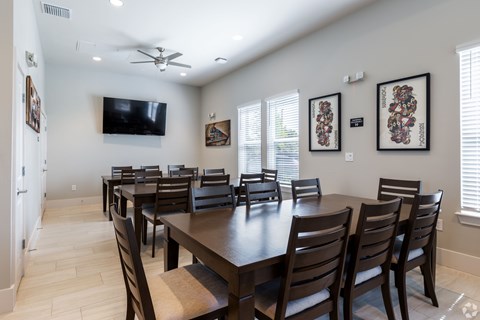 A dining room with a long table and chairs.