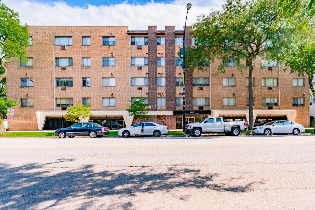 a large brick building with cars parked in front of it